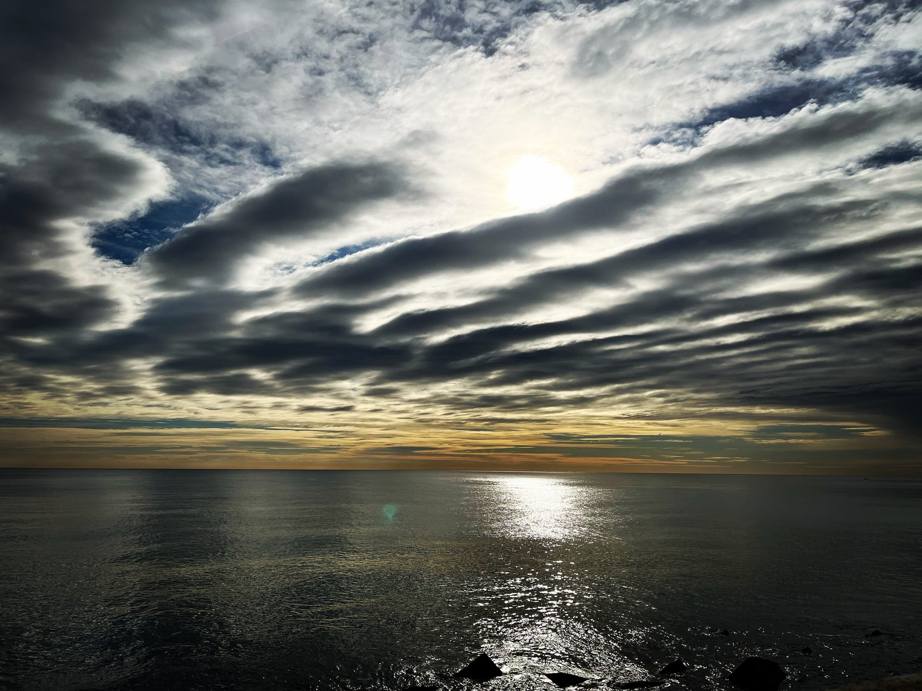 Nubes peinadas — Nubes alargadas y estriadas sobre el mar al atardecer